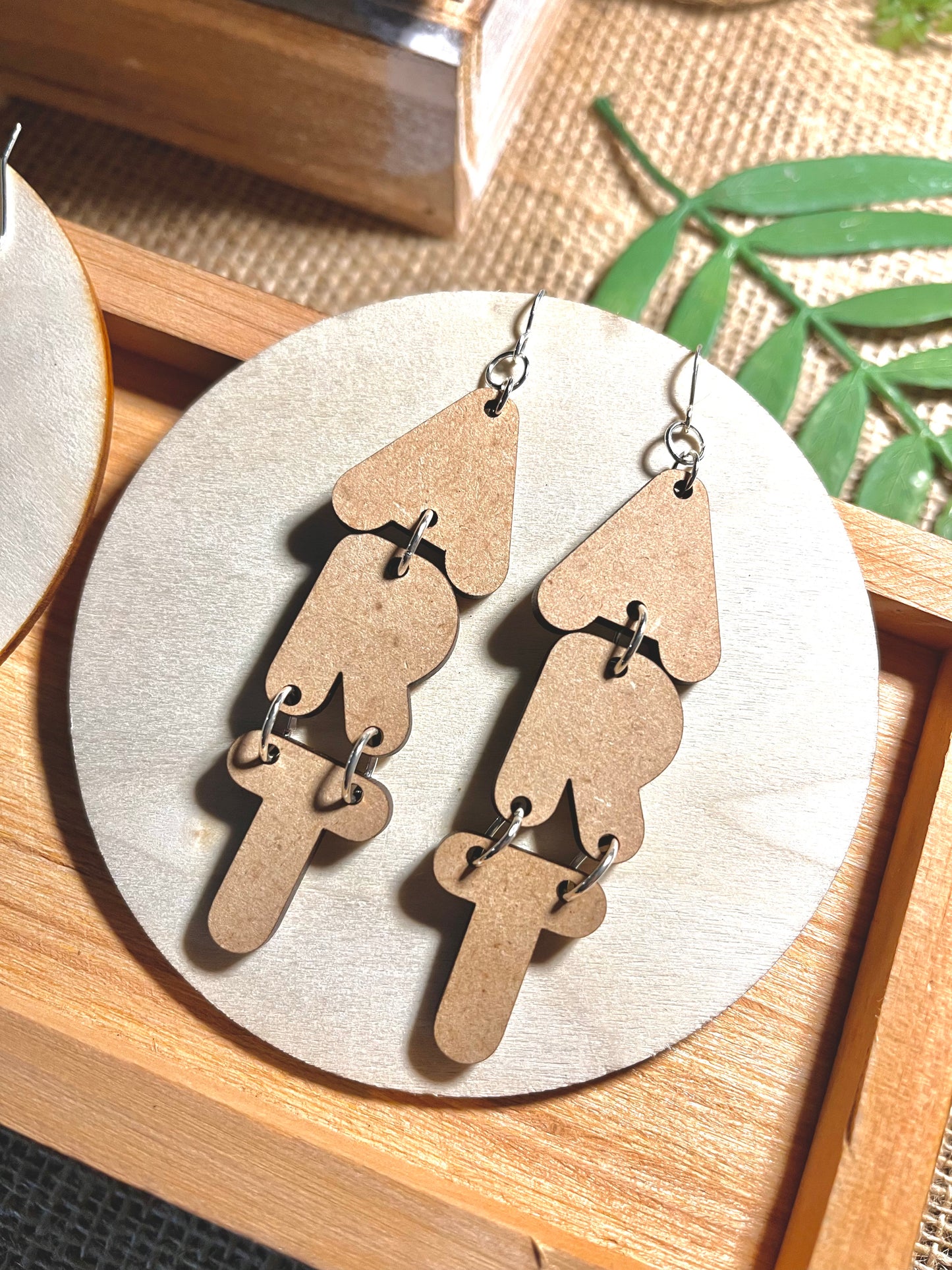 ART Earrings. Earrings made of wood cut out in the shape of letters to spell the word "Art". They hang vertically and are ~ 3" in length