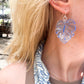Blue Acrylic Earrings in the shape of a Monstera leaf. Approximately 1.5" x 1.6"