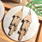 ART Earrings. Earrings made of wood cut out in the shape of letters to spell the word "Art". They hang vertically and are ~ 3" in length